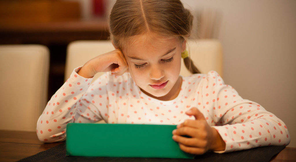 Little kid watching an IPAD