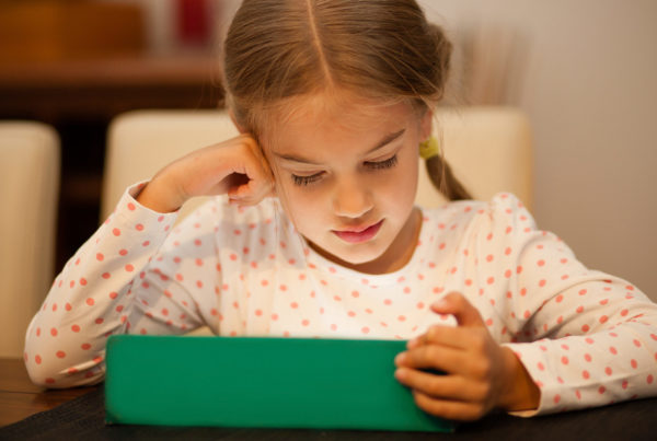 Little kid watching an IPAD